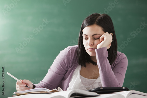 Bored Caucasian student doing homework