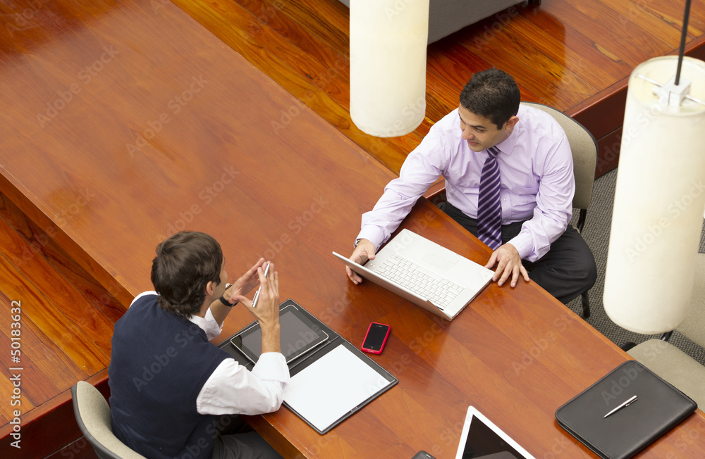 Hispanic businessmen having meeting in conference room Hispanic businessmen having meeting in conference room