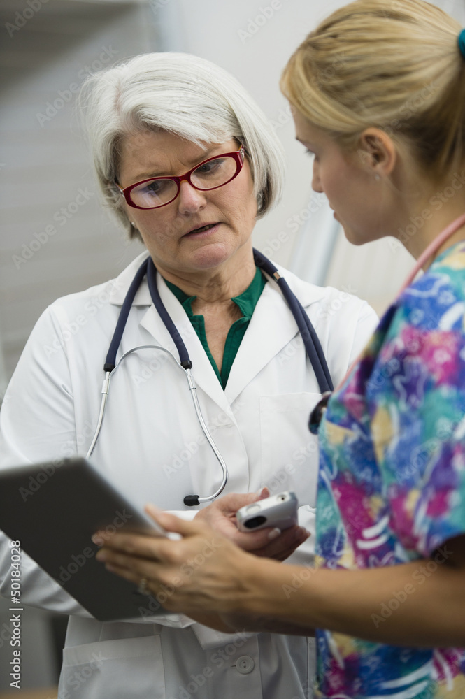 Caucasian nurse and doctor using digital tablet Caucasian nurse and doctor using digital tablet