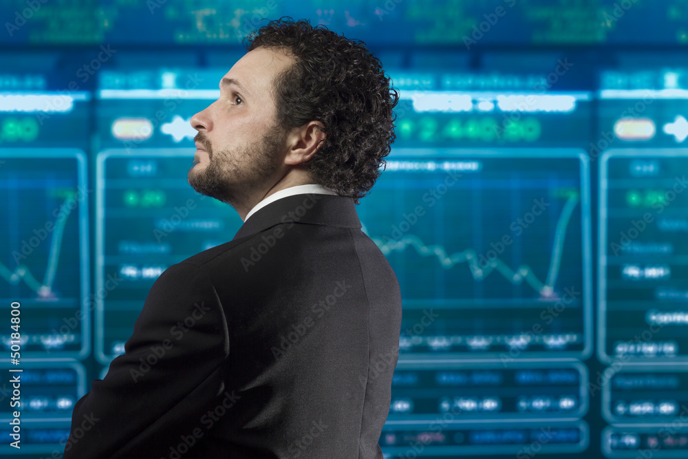 Fototapeta premium businessman with beard and black suit in the stockmarket, back