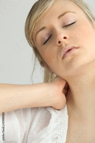 Blond girl with neck ache