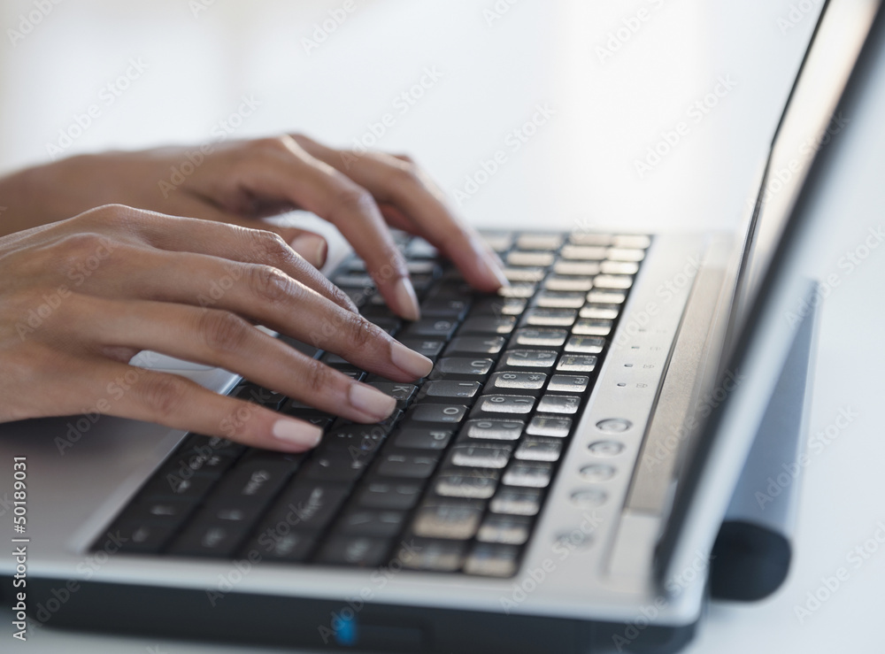 Cape Verdean woman typing on laptop Cape Verdean woman typing on laptop
