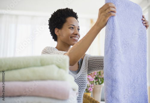 African American woman folding towels