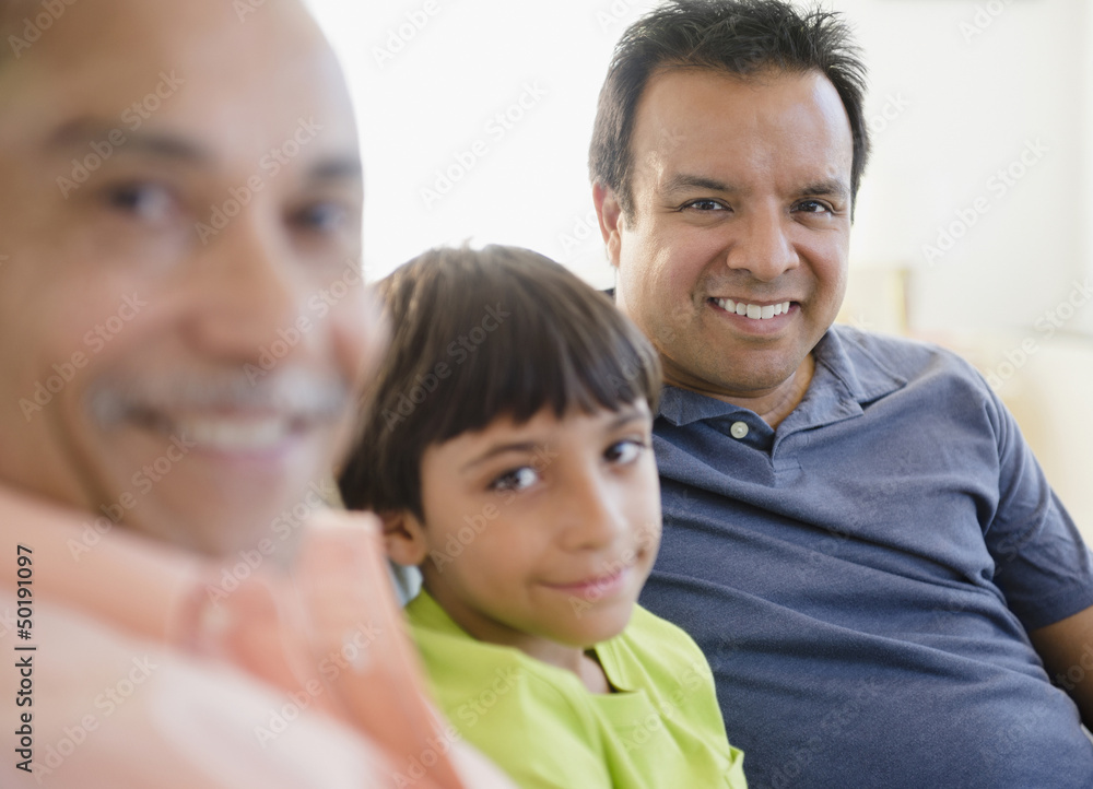 Smiling Hispanic grandfather, father and son Smiling Hispanic grandfather, father and son