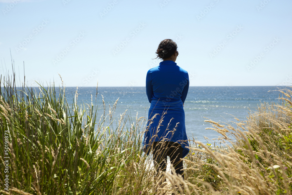 Mixed race woman looking at ocean Mixed race woman looking at ocean