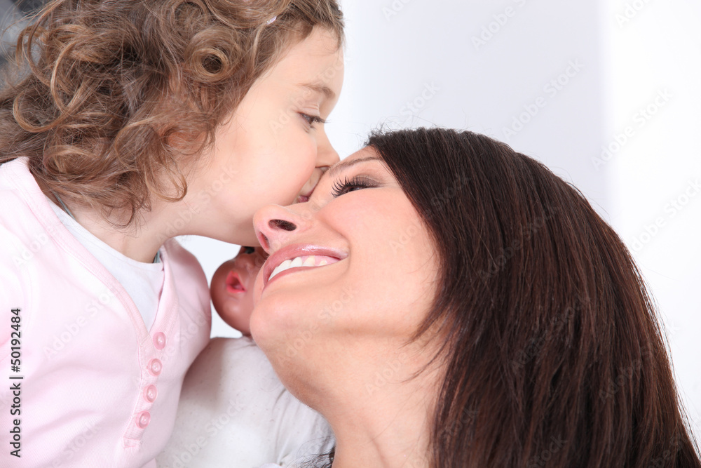 Girl kissing her mother Girl kissing her mother