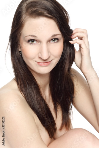 Portrait of a naked beautiful brunette in the studio