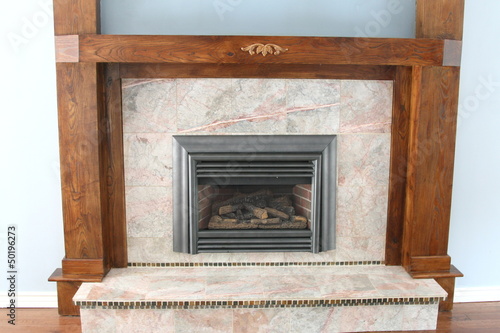Gas fireplace with granite and wood trim © nadine