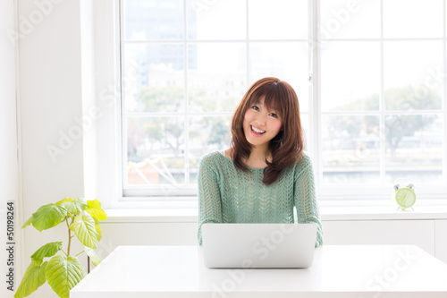 attractive asian woman using computer Free Download attractive asian woman using computer - GFXLoad