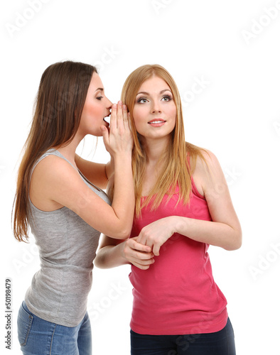 Two girl friends gossip isolated on white