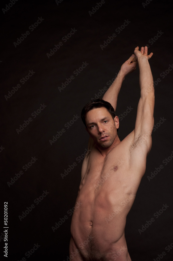 Young attractive guy without a shirt. Handsome naked man posing in studio. Atelt. Fitness and healthy lifestyle. Young attractive guy without a shirt. Handsome naked man posing in studio. Atelt. Fitness and healthy lifestyle.