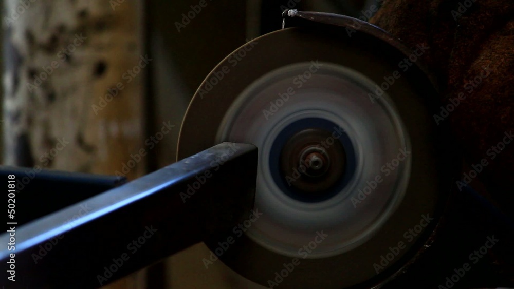 Worker sawing metal with electrical saw, grinder. Worker sawing metal with electrical saw, grinder.