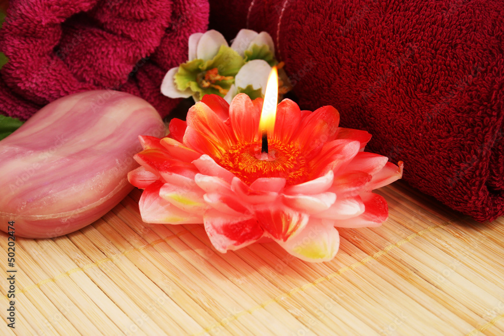 Towels, soap, flowers, candle Towels, soap, flowers, candle
