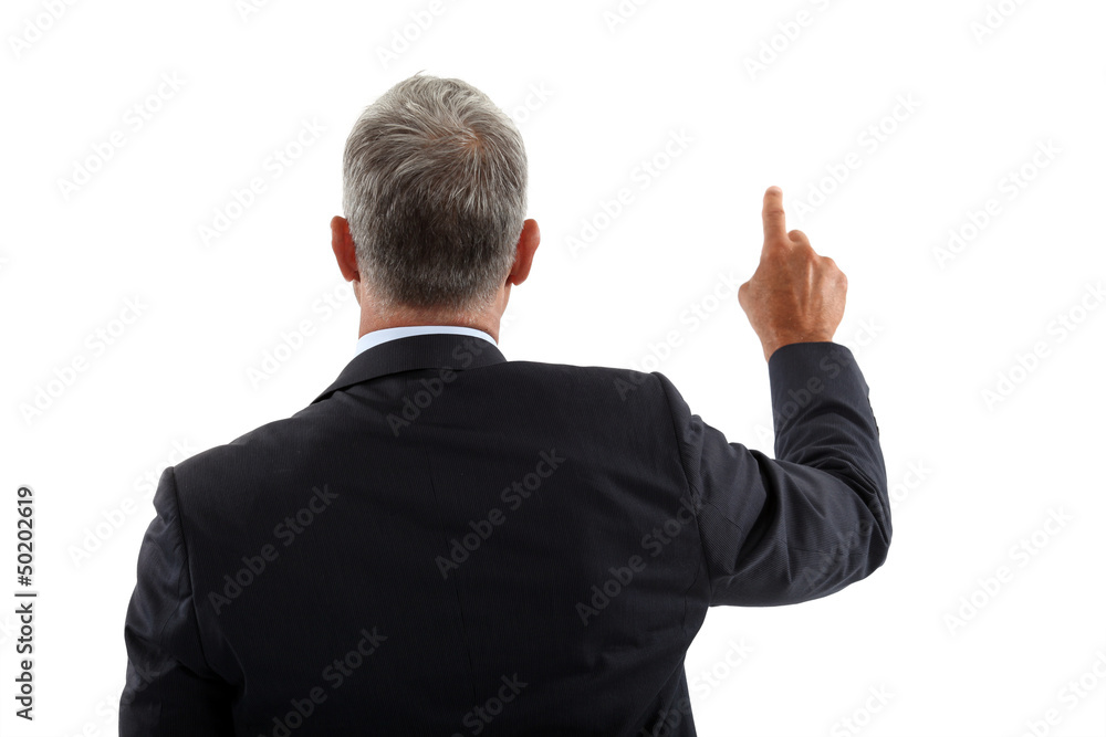 view of a back of a businessman pushing a button view of a back of a businessman pushing a button
