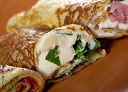 rolled pancakes stuffed ham and cheese. photo