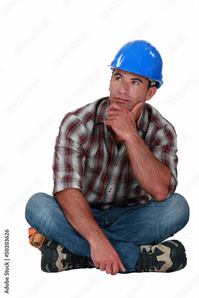 A pensive manual worker. A pensive manual worker.