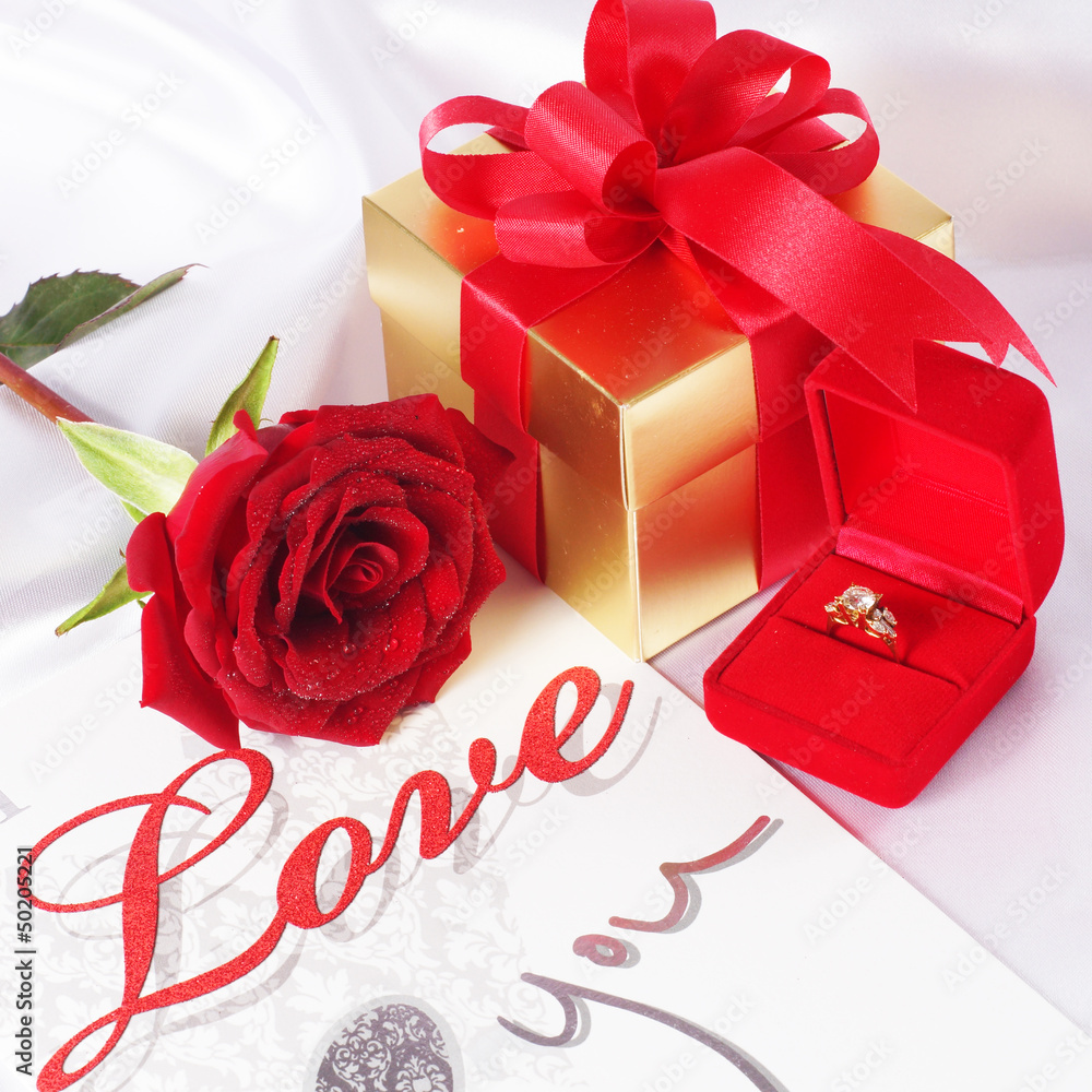 Golden diamond ring with gift box and red rose