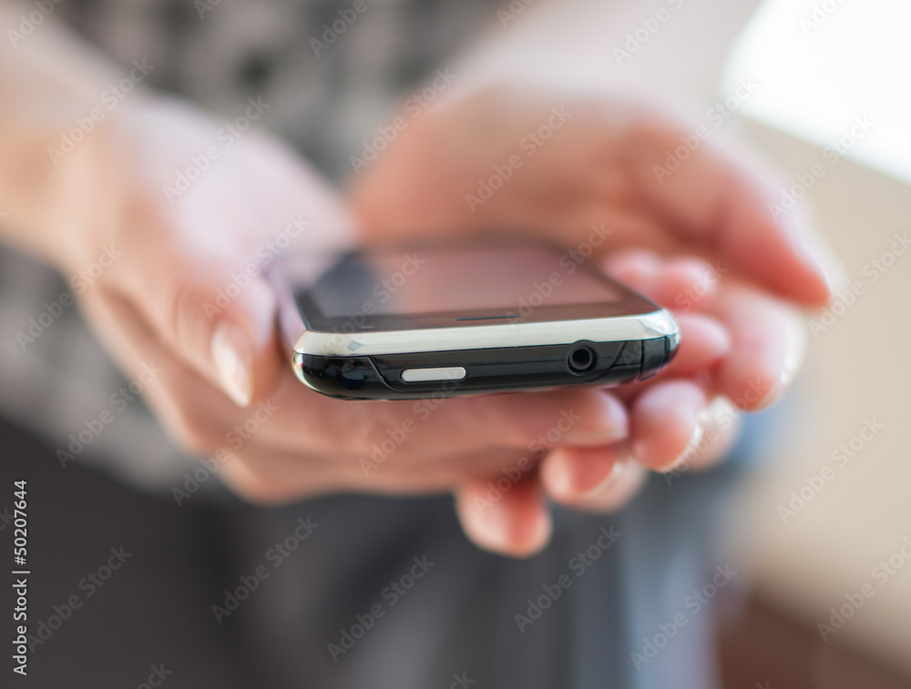 A woman uses a mobile phone A woman uses a mobile phone