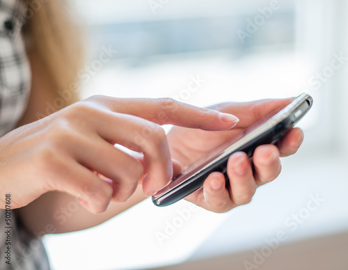 A woman uses a mobile phone