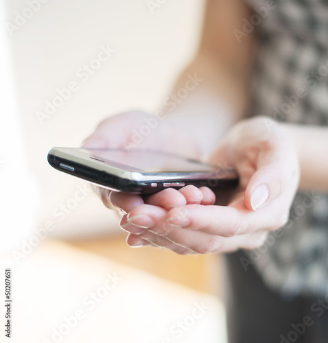 A woman uses a mobile phone