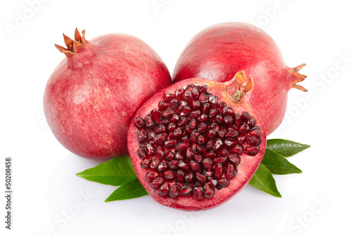Pomegranate and section with leaves on white with clipping path