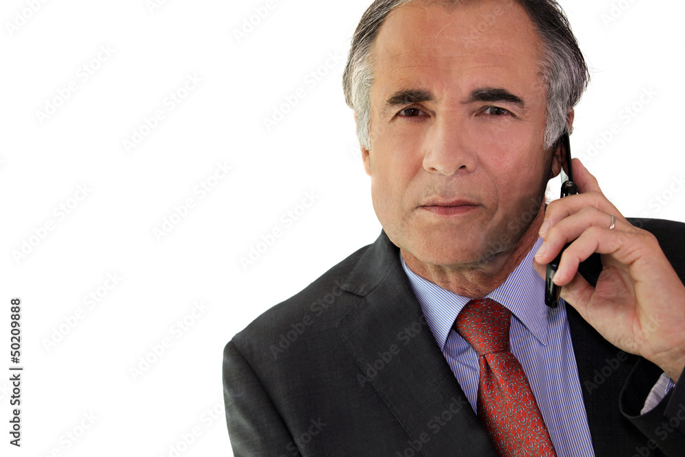 Businessman using a cellphone in the office Businessman using a cellphone in the office