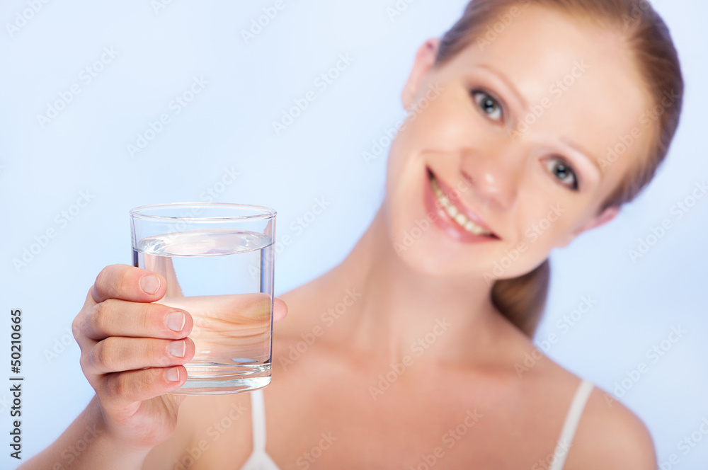 young healthy woman and a glass of clean water young healthy woman and a glass of clean water