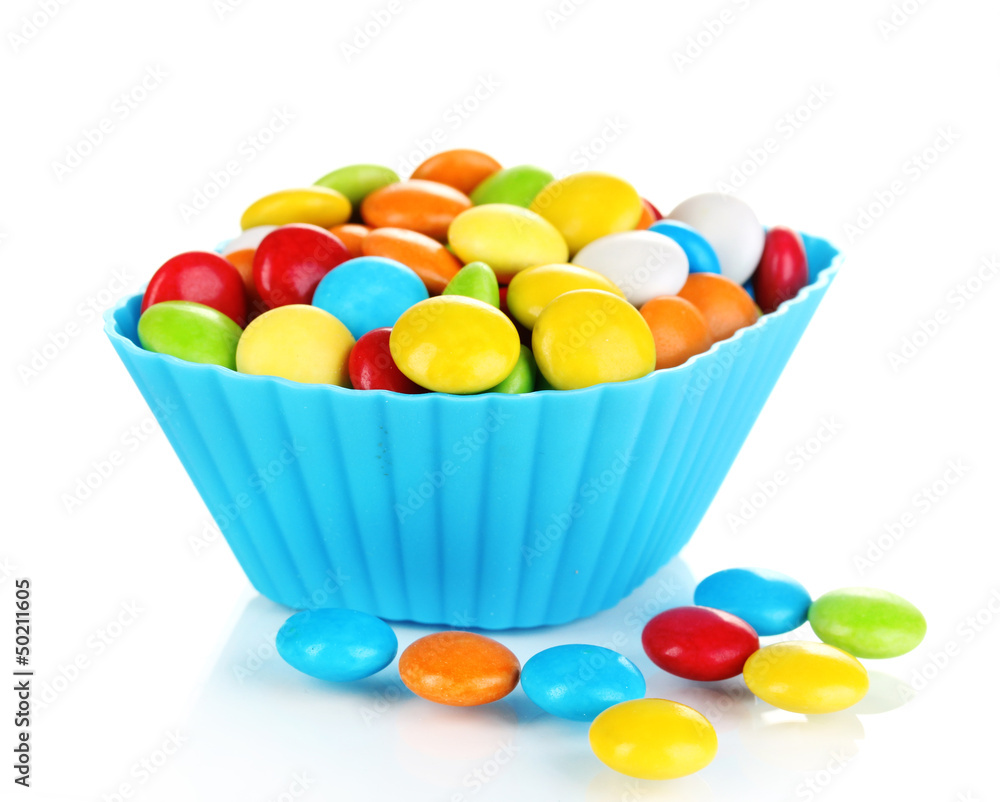 Colorful candies in cupcake case isolated on white Colorful candies in cupcake case isolated on white