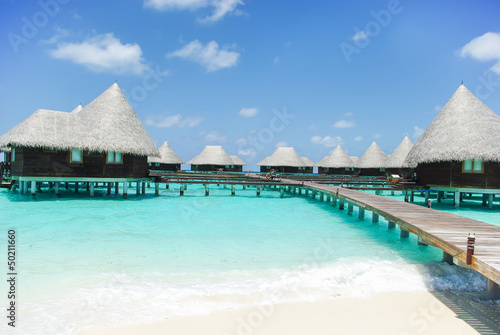 Water villas on tropical island on Maldives