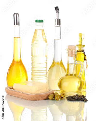 Different types of oil with sunflower seeds and olives isolated