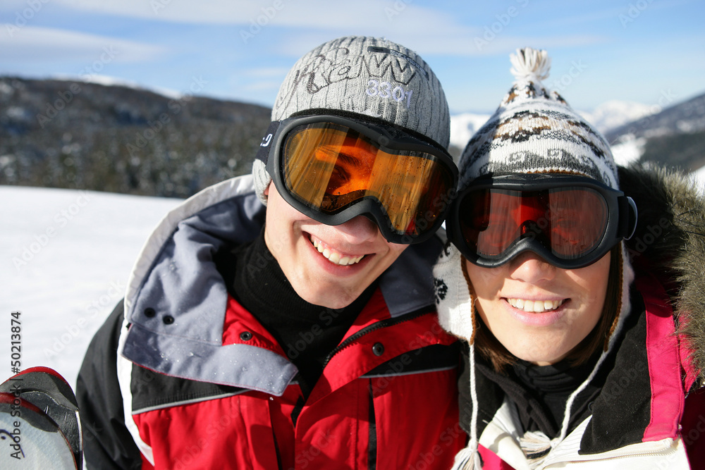 Skiing couple laying in the snow Skiing couple laying in the snow