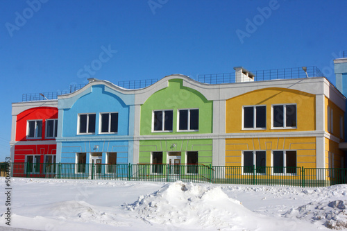 Modern colorful houses against a blue sky in the winter © argot