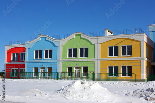 Modern colorful houses against a blue sky in the winter