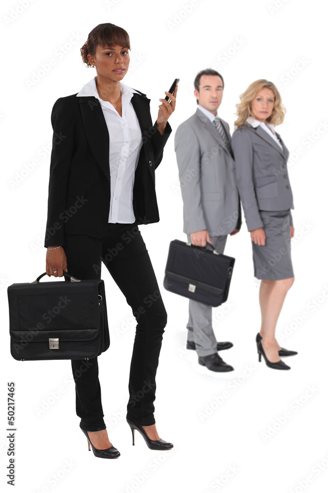Three businesspeople standing together Three businesspeople standing together