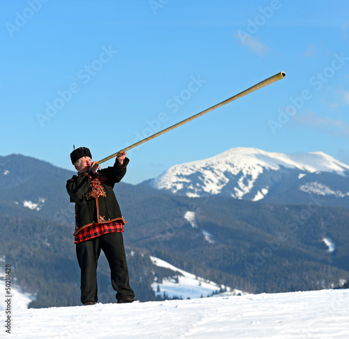 A man with trembitas photo