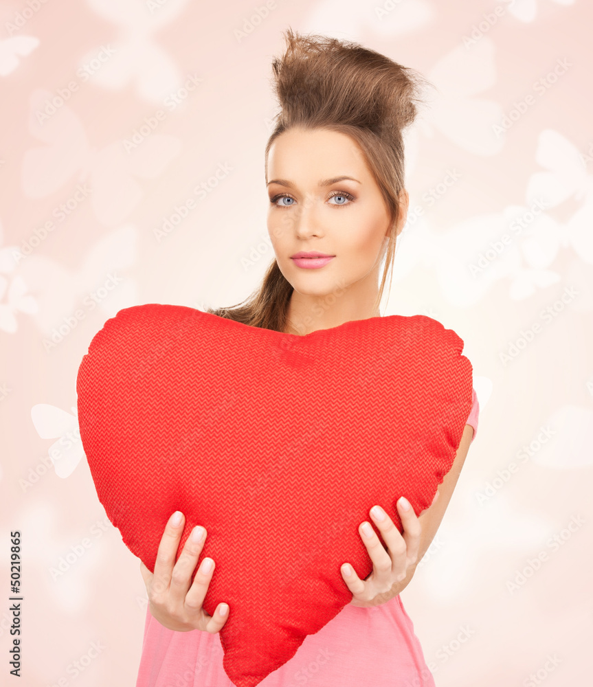 happy and smiling woman with heart-shaped pillow happy and smiling woman with heart-shaped pillow