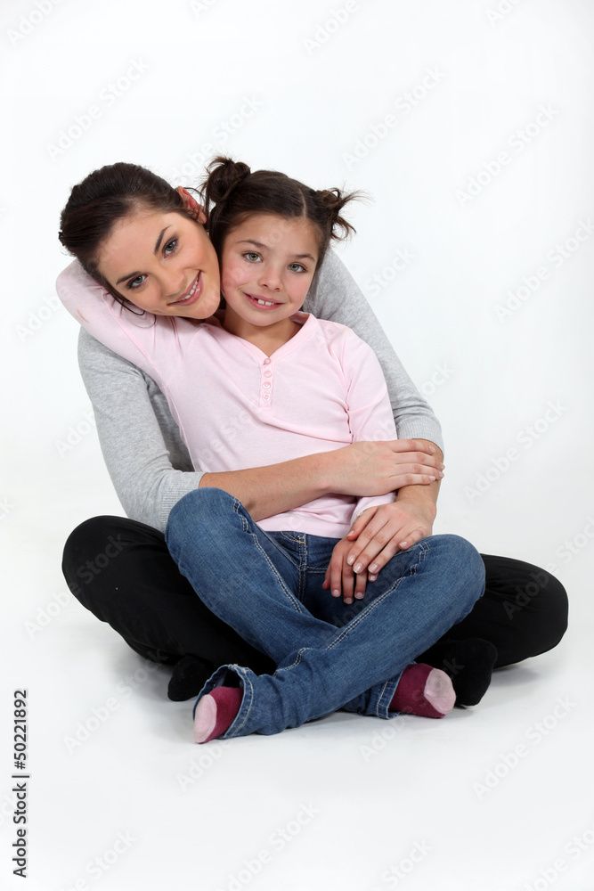A mother and her daughter hugging.