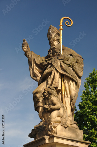Saint Augustine statue holding  Charles Bridge Prague