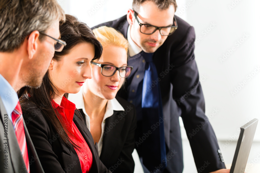 Businesspeople looking at laptop screen Businesspeople looking at laptop screen