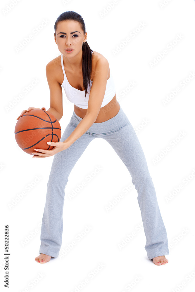 Woman standing and holding basketball Woman standing and holding basketball