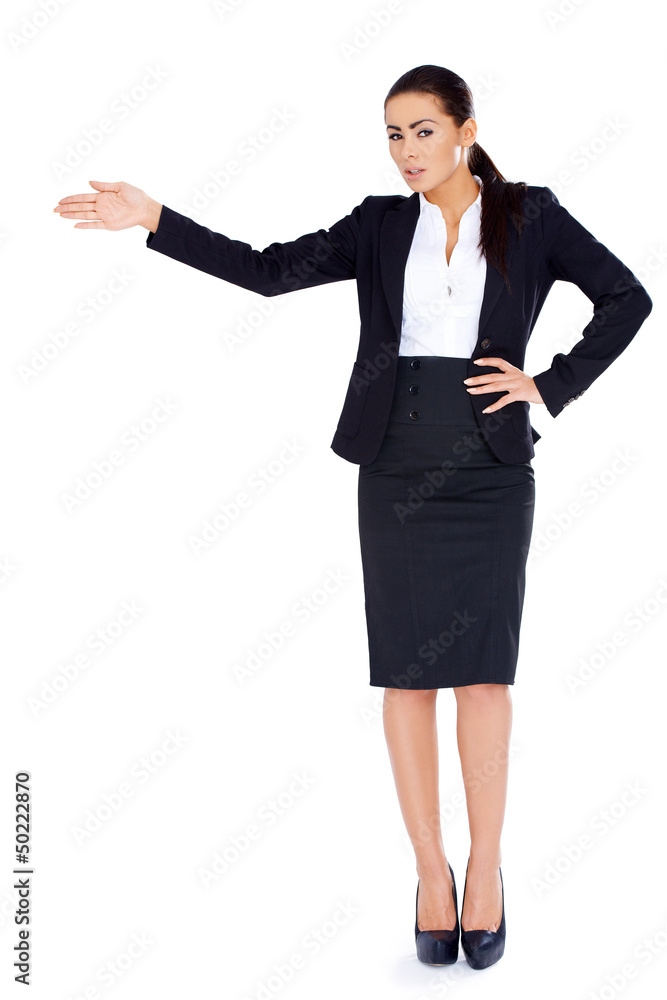 Business woman standing and pointing at copy space Business woman standing and pointing at copy space