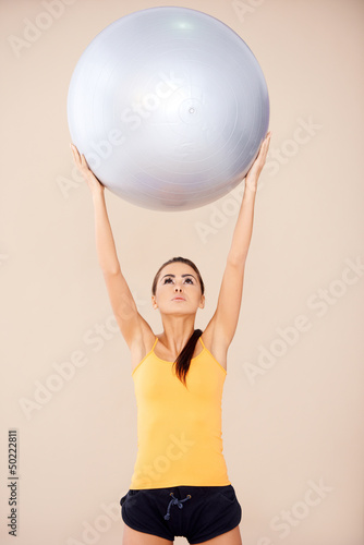 Woman doing exercises with fitness ball