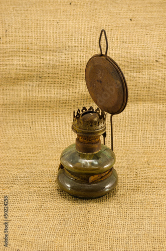 rusty retro paraffin lamp burlap background