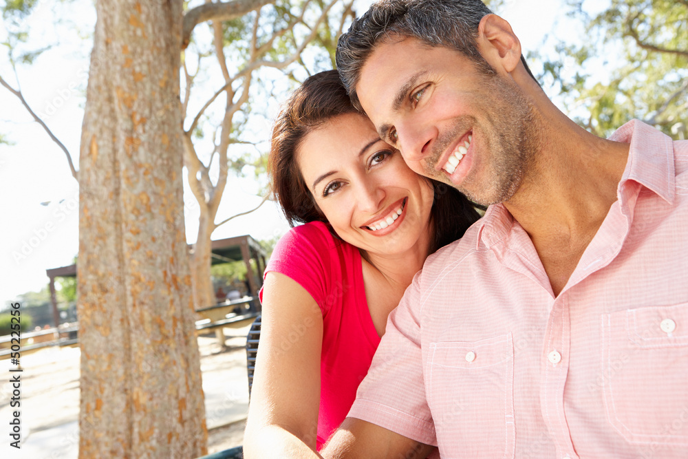 Romantic Couple Sitting On Park Bench Together Romantic Couple Sitting On Park Bench Together