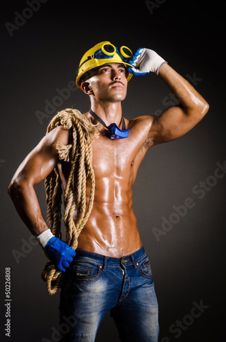 Construction worker in dark studio © Elnur