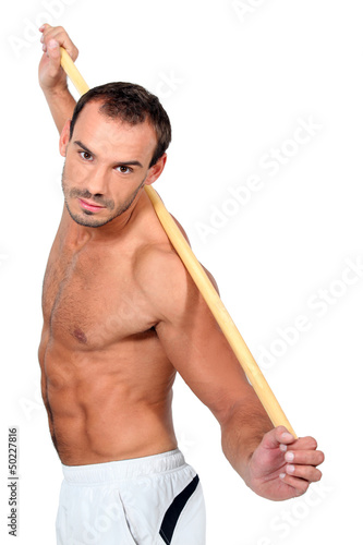 man doing exercises with a stick