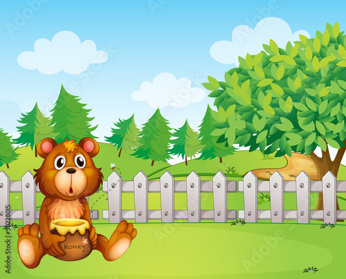 A bear inside the fence holding a pot of honey