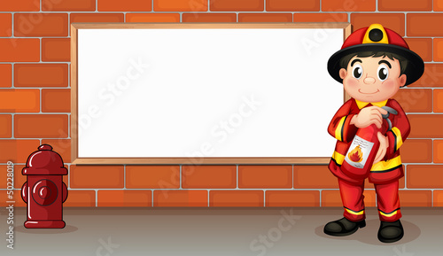 A fireman with a fire extinguisher in front of an empty board