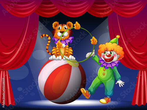 A tiger and a clown performing at the stage