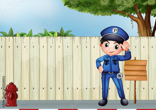 A police officer beside an empty wooden signage